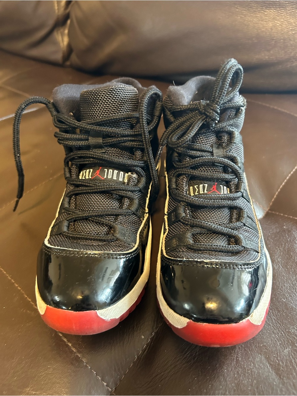 Jordan 11  Kids Black and Red High-Top Sneakers with Patent Toe